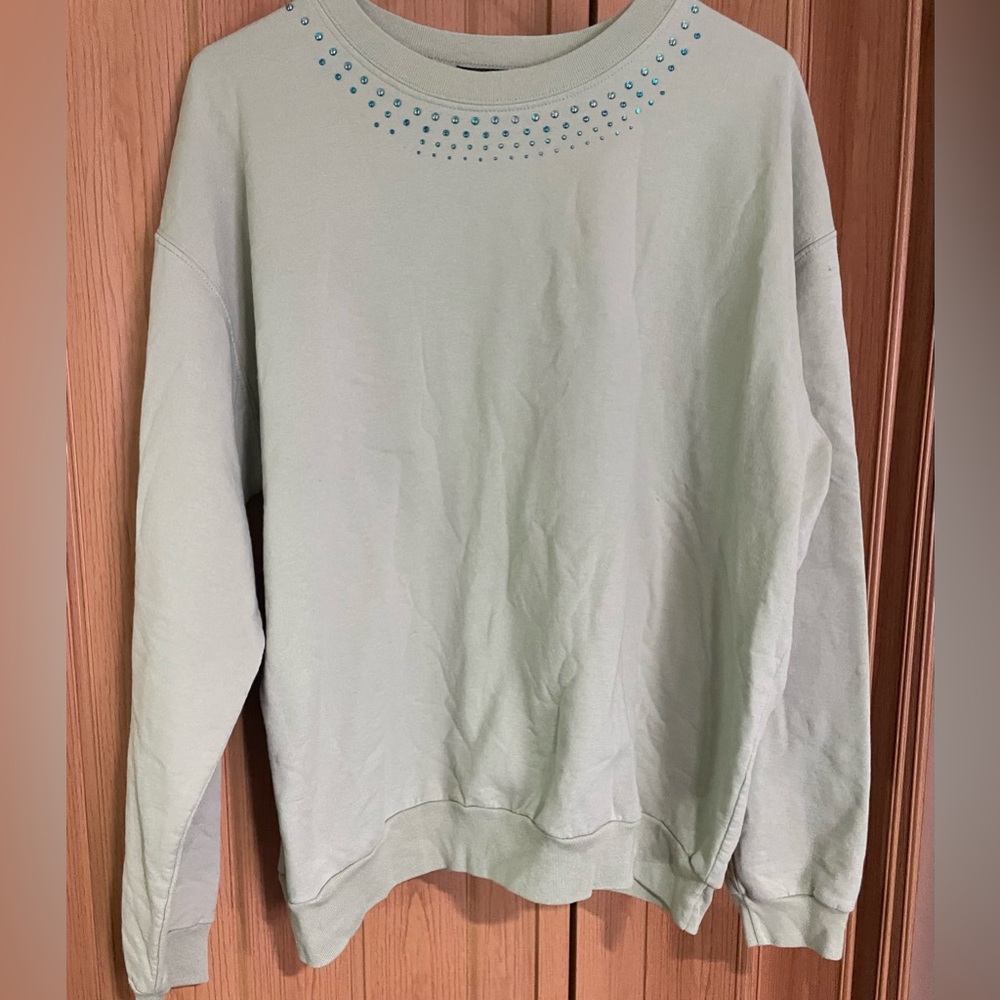 Sunburst XL sweatshirt. Tan color with blue/green rhinestones